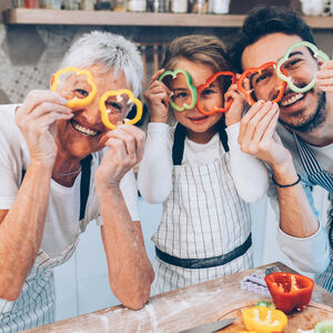 3 people holding peppers over their eyes