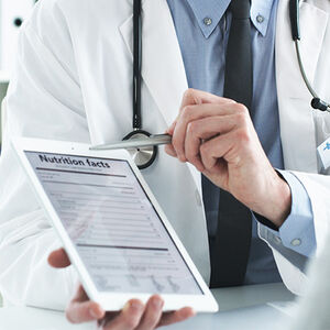 Image of a doctor showing nutritional facts on an iPad to a patient
