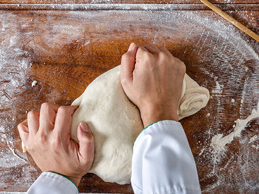 Image of a man kneading dough